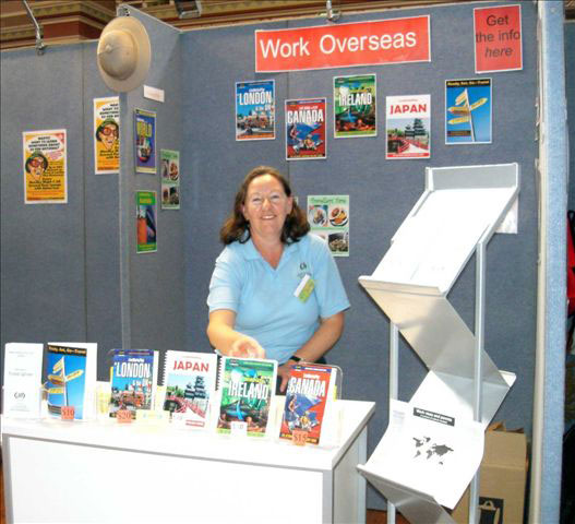 Sharyn McCullum surrounded by her Work Overseas travel guides at Melbourne's Backpacker Expo.
